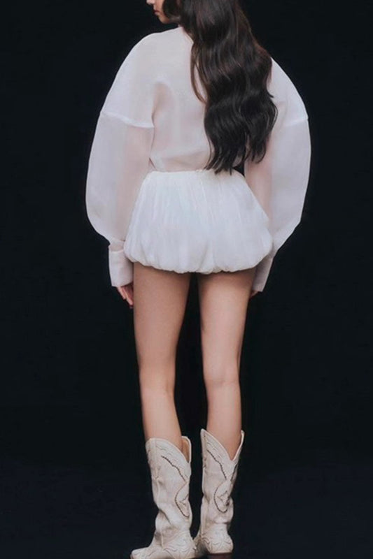 Fashionable loose langry top: white sheer blouse with ruffled hem and cream cowboy boots