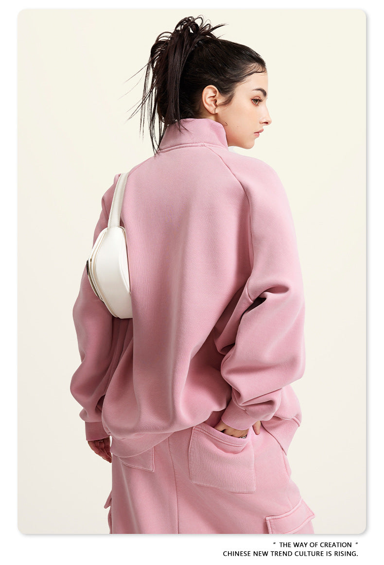 Pink oversized turtleneck sweatshirt paired with a white handbag for winter fashion ملابس