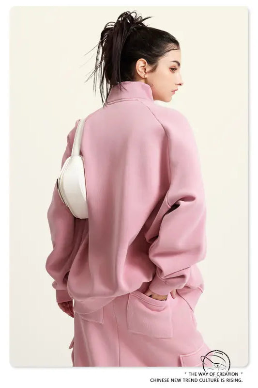 Pink winter heavy retro jacket with oversized turtleneck and white handbag