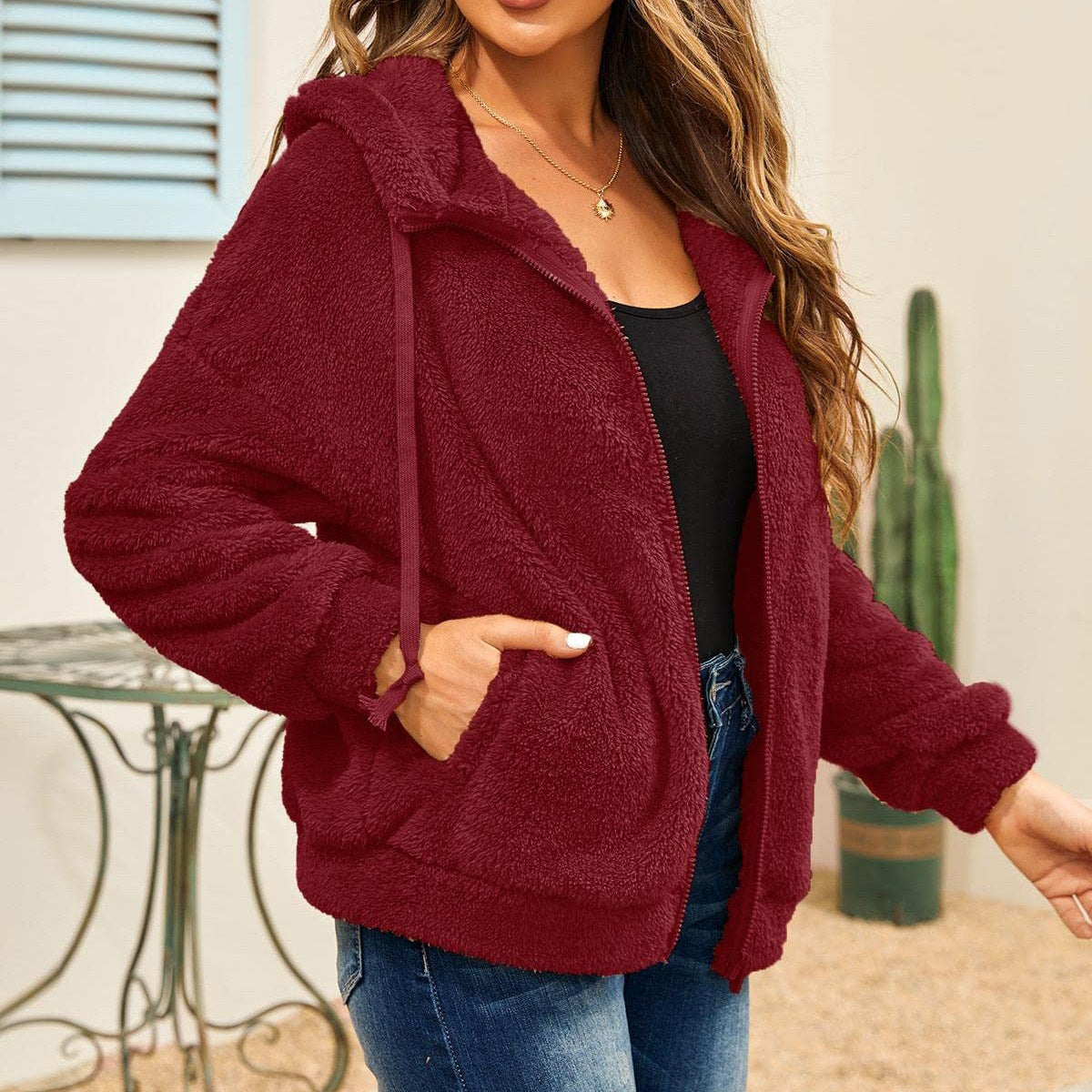 Burgundy hooded sherpa jacket on a cute fleece sweater with long sleeve zipper detail