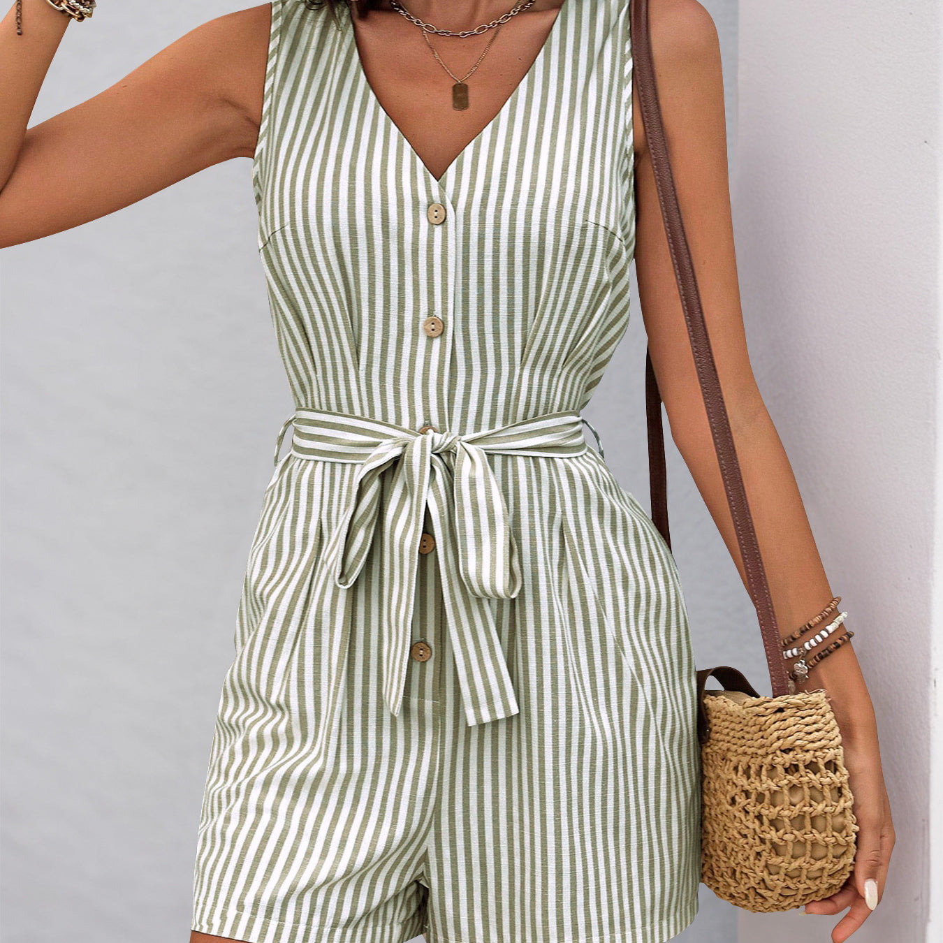 Sleeveless green and white striped romper with v-neck and waist tie for summer fashion