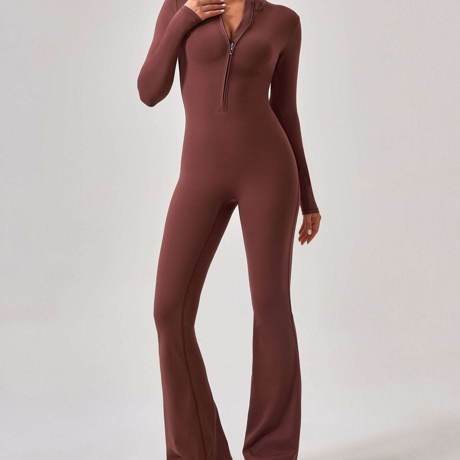 Brown long-sleeved zip-front jumpsuit with flared legs for fashionable sportswear ملابس
