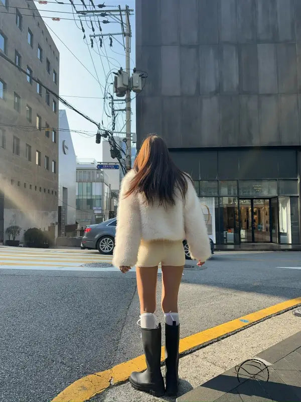 Langry short faux fur coat with black rubber boots and white socks