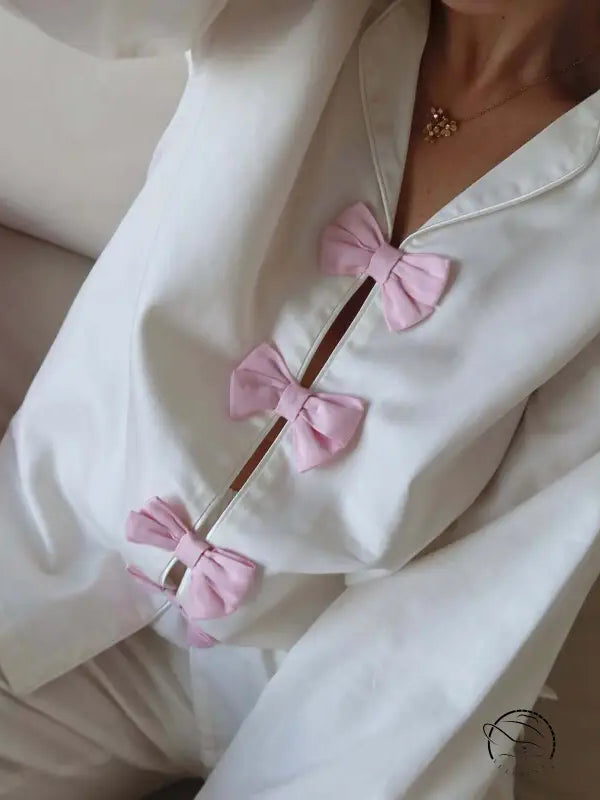 White cotton langry fashion pajamas with pink bow accents and buttons