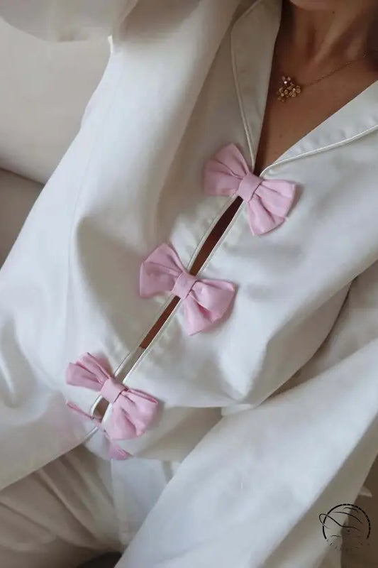 White cotton langry fashion pajamas with pink bow accents and buttons