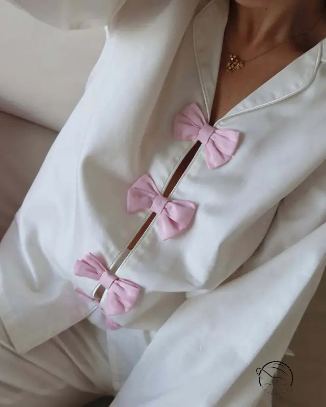 White cotton langry fashion pajamas with pink bow accents and buttons