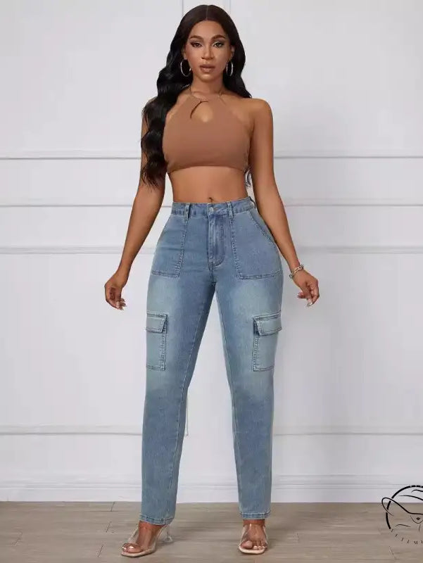 Straight skinny jeans in light wash blue with brown one-shoulder crop top