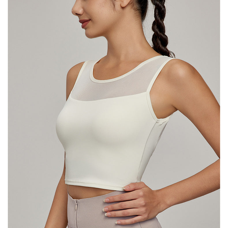 Woman wearing cream-colored athletic crop top with mesh yoke from Beauty Back Mesh Workout Top, perfect for fashion and ملابس