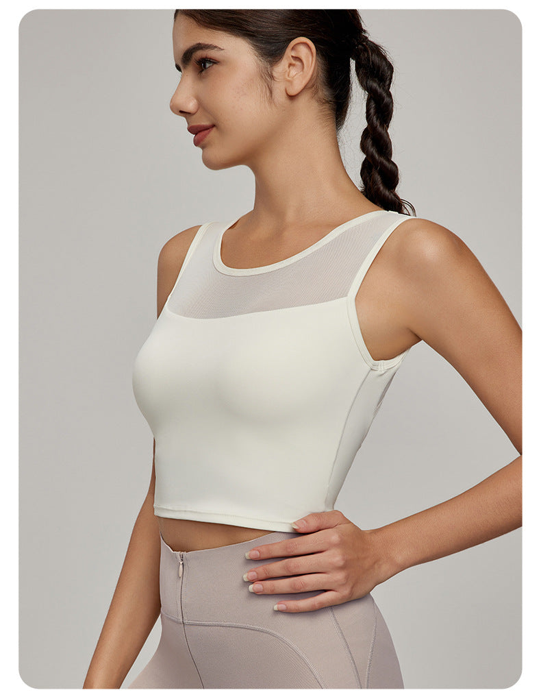 Woman wearing cream-colored athletic crop top with mesh yoke from Beauty Back Mesh Workout Top, perfect for fashion and ملابس