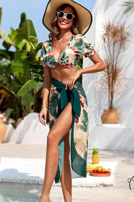 Woman in metal high waist bikini swimsuit with tropical print sarong