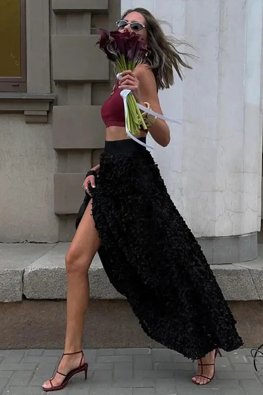 Stylish woman with flowers in winter petal design long skirt