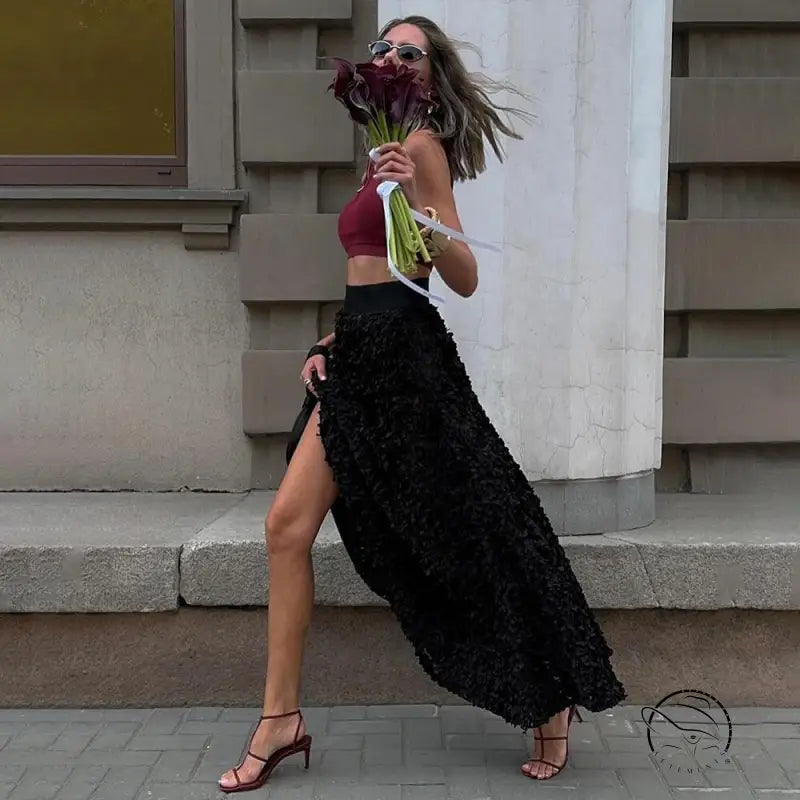 Stylish woman with flowers in winter petal design long skirt