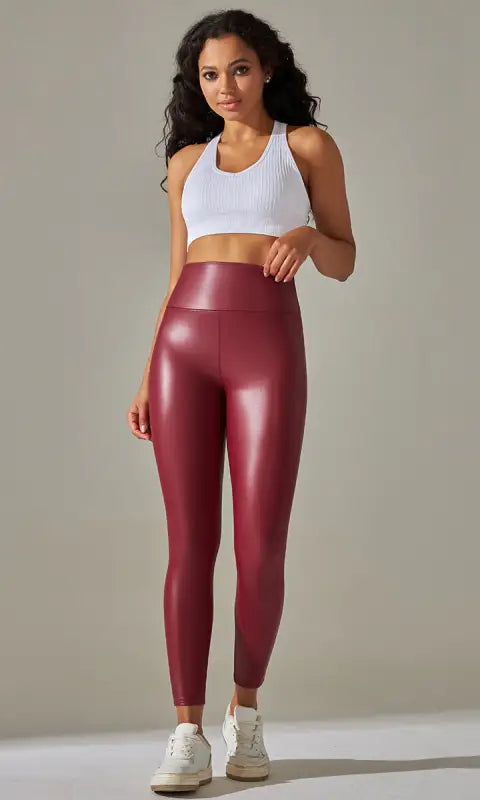 Maroon high waist faux leather leggings with glossy finish and white tank top
