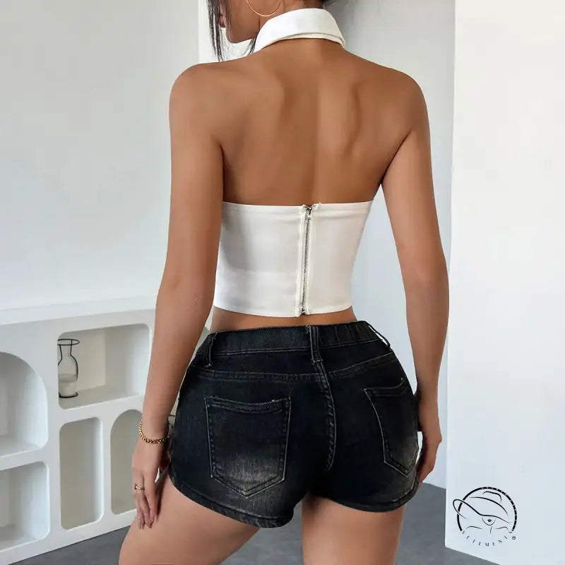 Back view of wild leopard halter crop top with denim shorts