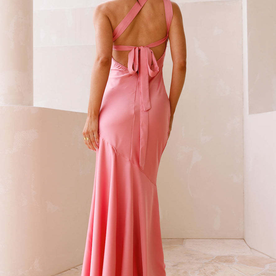 Sleek coral pink fishtail dress with tie-back halter design and mermaid silhouette