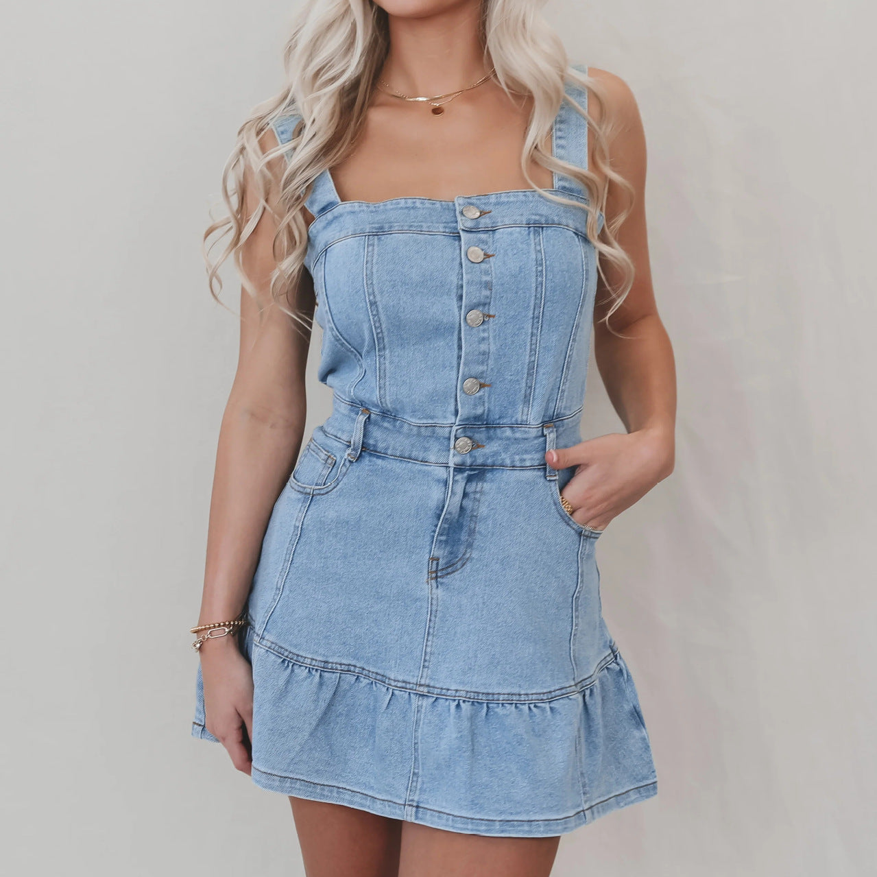 Light-wash denim mini dress with button-front bodice and ruffled hem, ideal for office suspenders denim style
