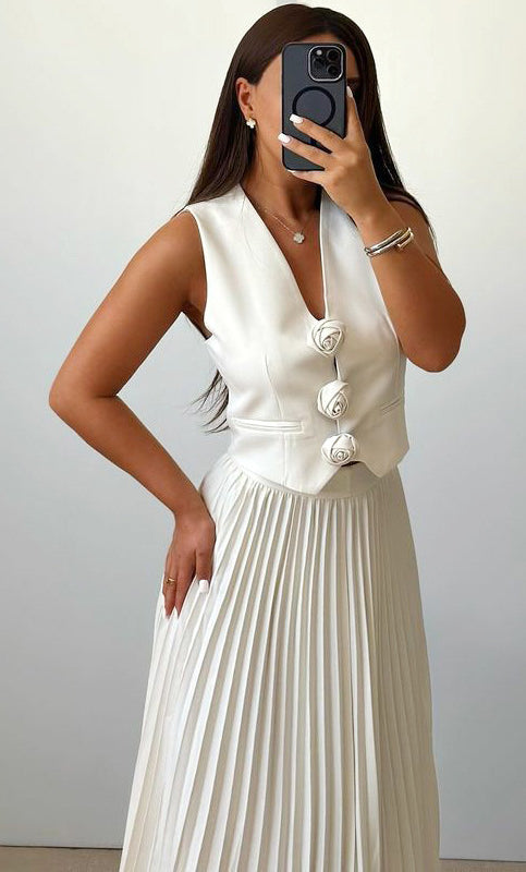 Elegant woman in white vest and pleated skirt showcasing high-grade summer fashion attire