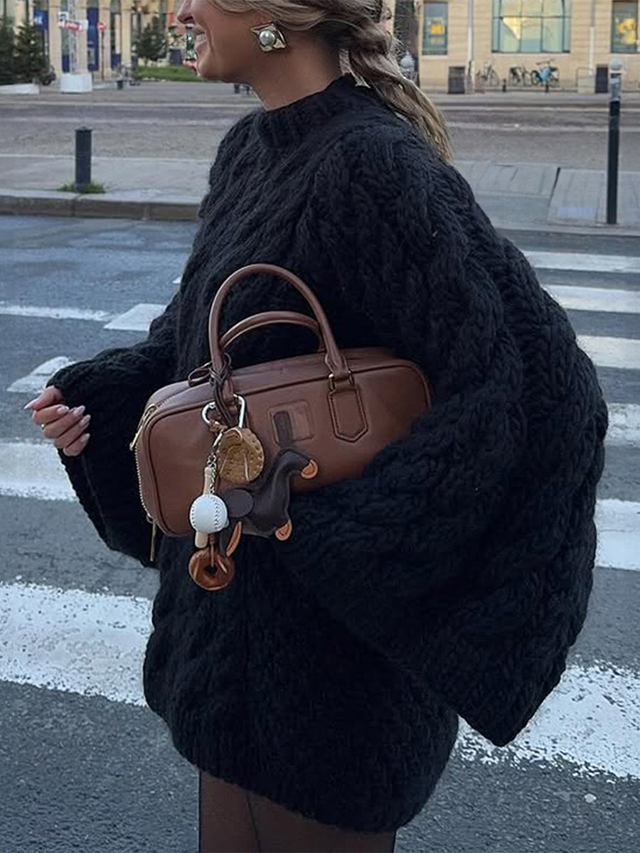 Brown leather handbag with gold hardware and white tassel charm for long sleeve fashion