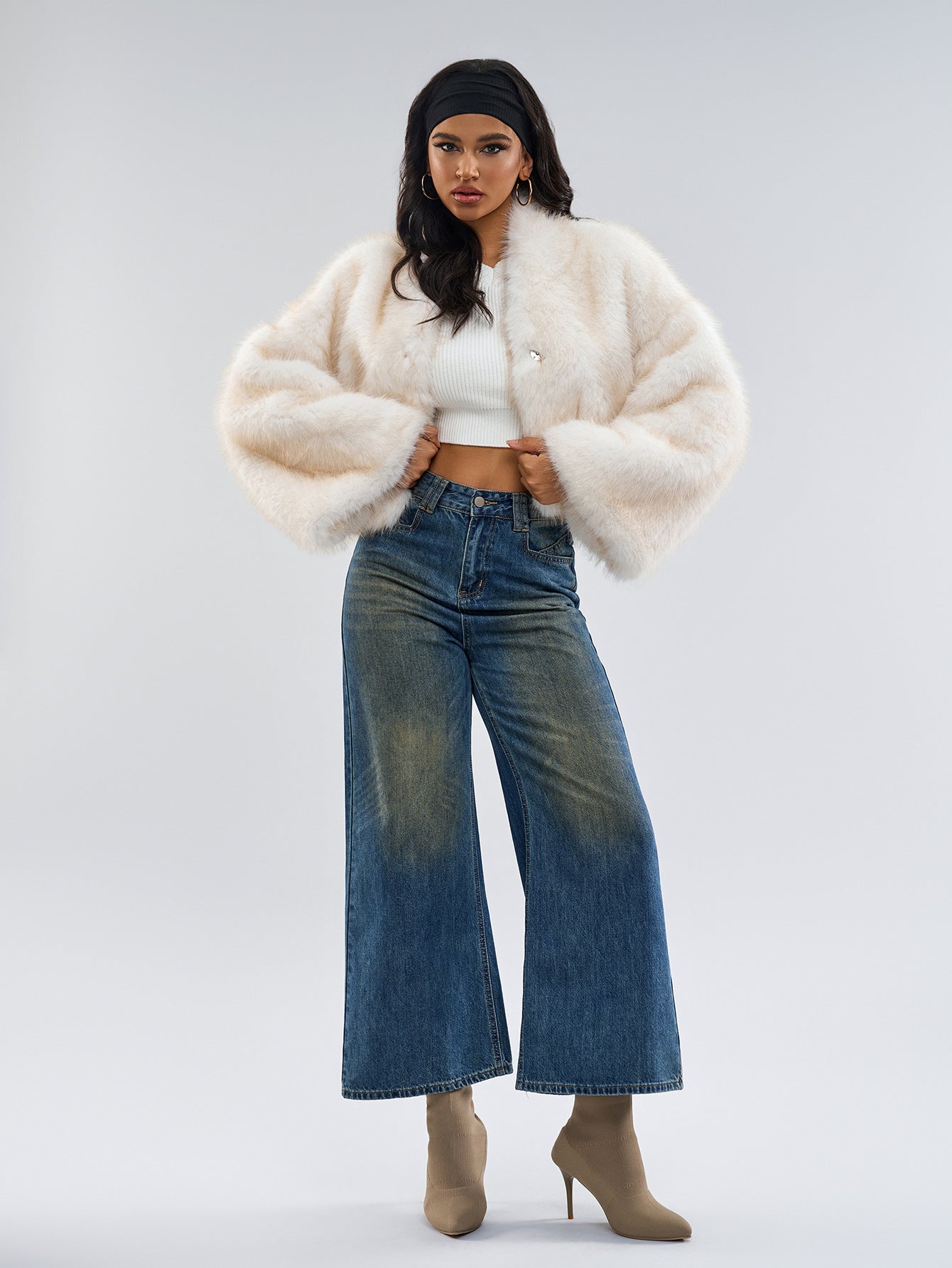Woman in a langry faux fur coat with wide-leg jeans and ankle boots, trendy ملابس fashion
