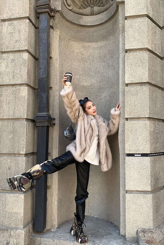 Langry faux fur winter jacket with black leather pants and silver boots