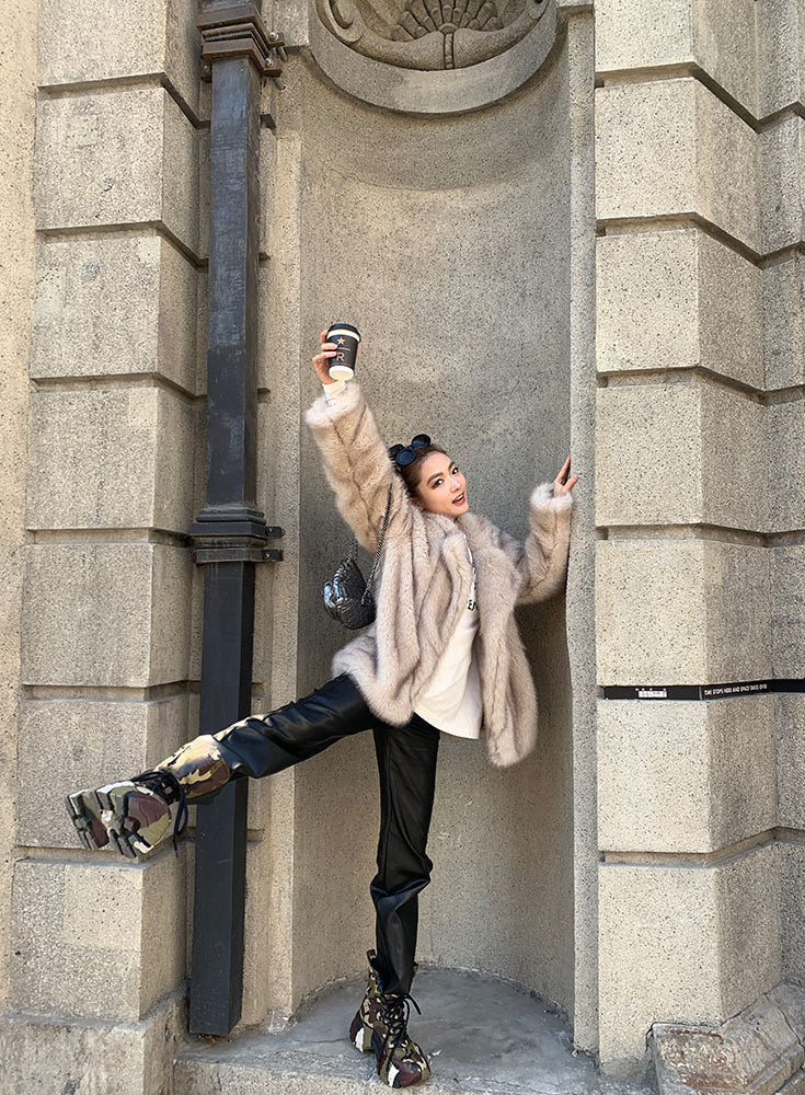 Langry faux fur winter jacket with black leather pants and silver boots