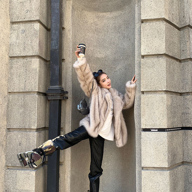 Langry faux fur winter jacket with black leather pants and silver boots