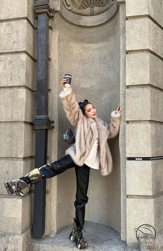 Langry faux fur winter jacket with black leather pants and silver boots