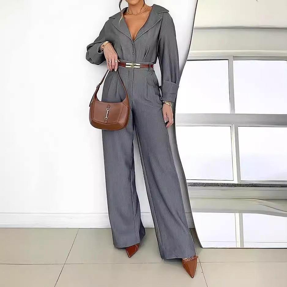 Gray polo collar jumpsuit with wide legs, brown belt, and matching shoulder bag for fashion