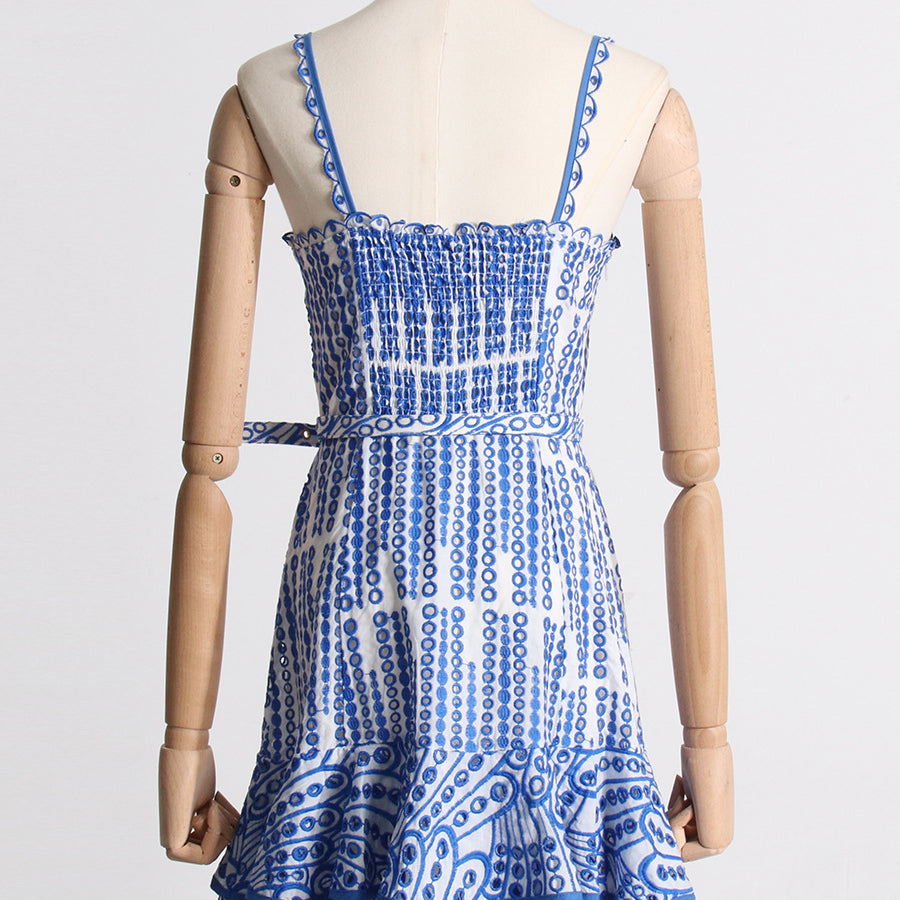Blue and white patterned sundress with ruffles, ideal for summer fashion ملابس