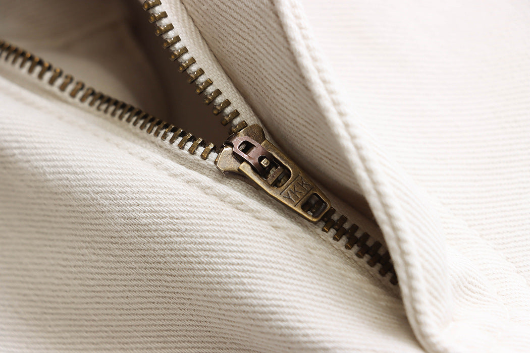 Metal zipper detail on white fabric of Street Design Wide Leg Jeans in fashion ملابس