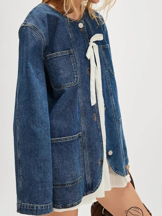 Woman modeling casual fashionable cowboy coat in denim with white ribbon detail