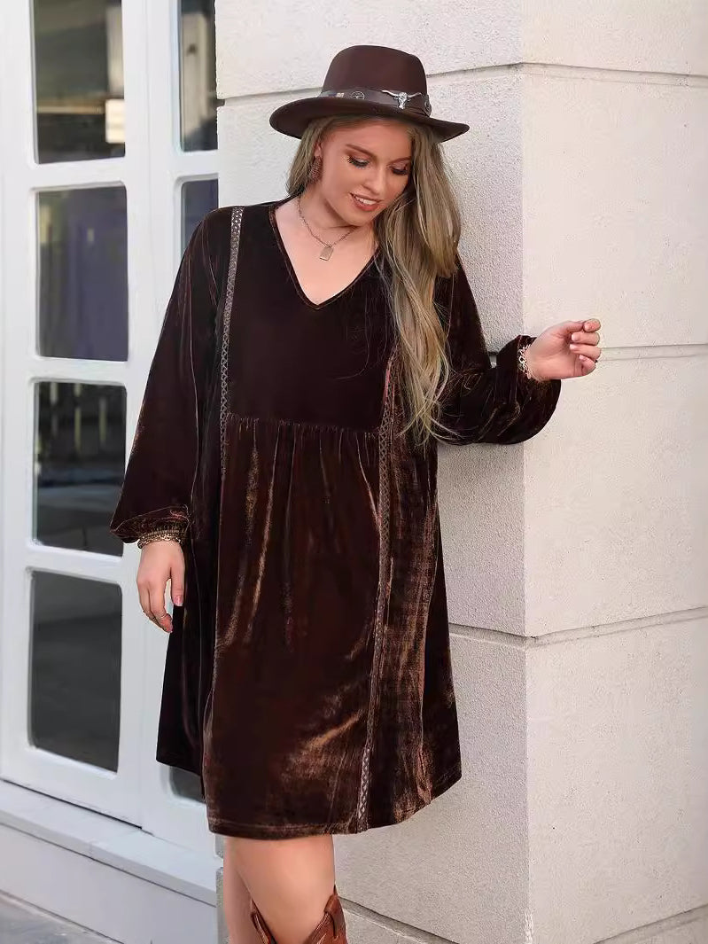 Woman wearing a long-sleeved brown velvet loose slimming casual dress with a wide-brimmed hat