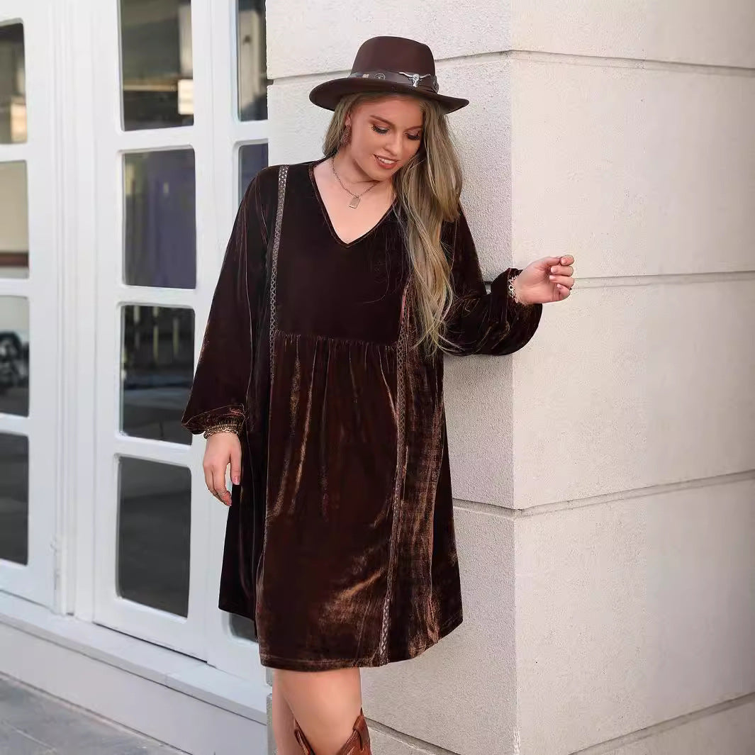 Woman wearing a long-sleeved brown velvet loose slimming casual dress with a wide-brimmed hat