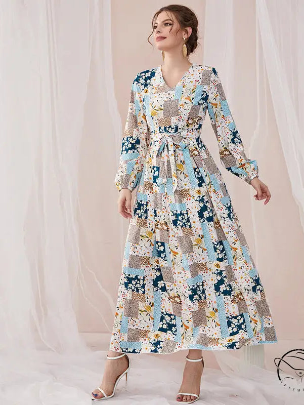 Woman in floral print slim fit maxi dress with blue beige white patchwork