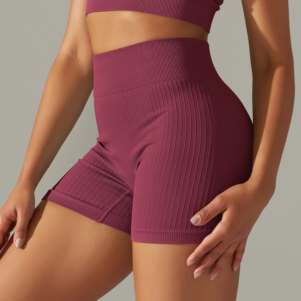 Seamless striped peach athletic shorts with maroon ribbed design for women’s fitness