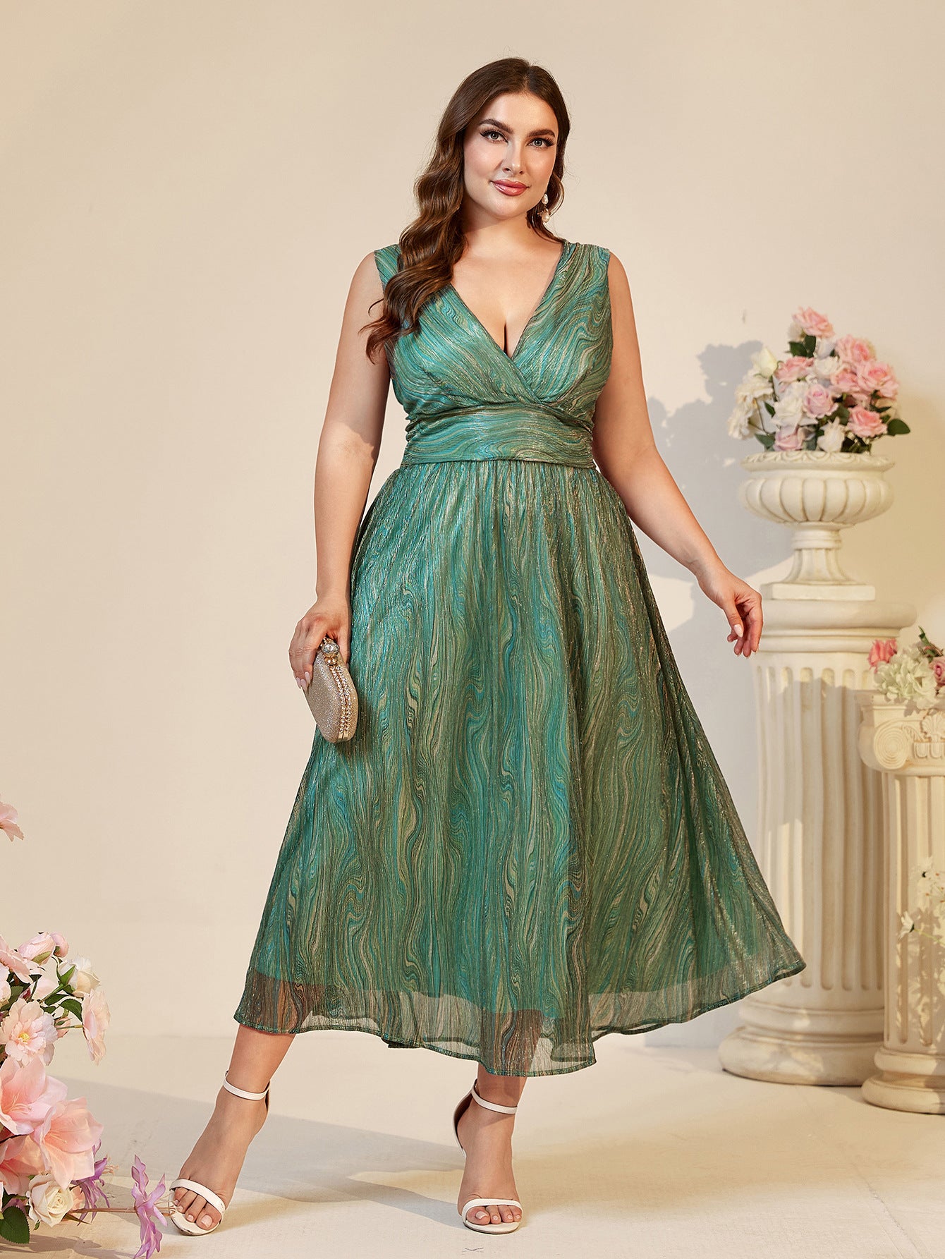 Beautiful suspender maxi dress in shimmering green fabric with abstract pattern