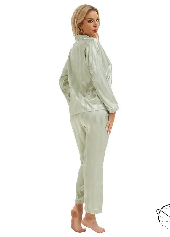 Woman in light green satin langry pajamas, long sleeves and tapered pants, fashion ملابس