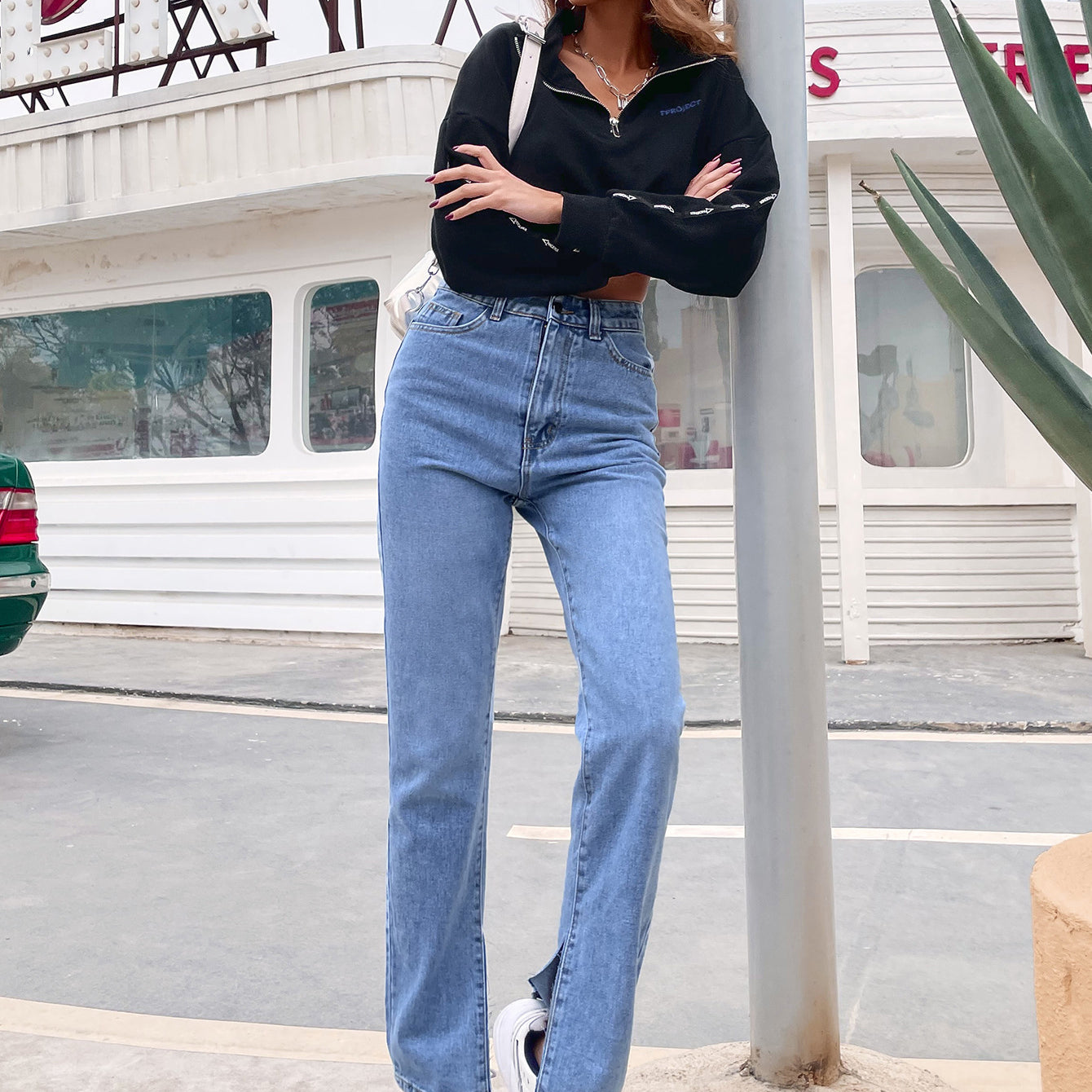 Women’s light wash high-waisted denim pants with front slits for casual fashion style
