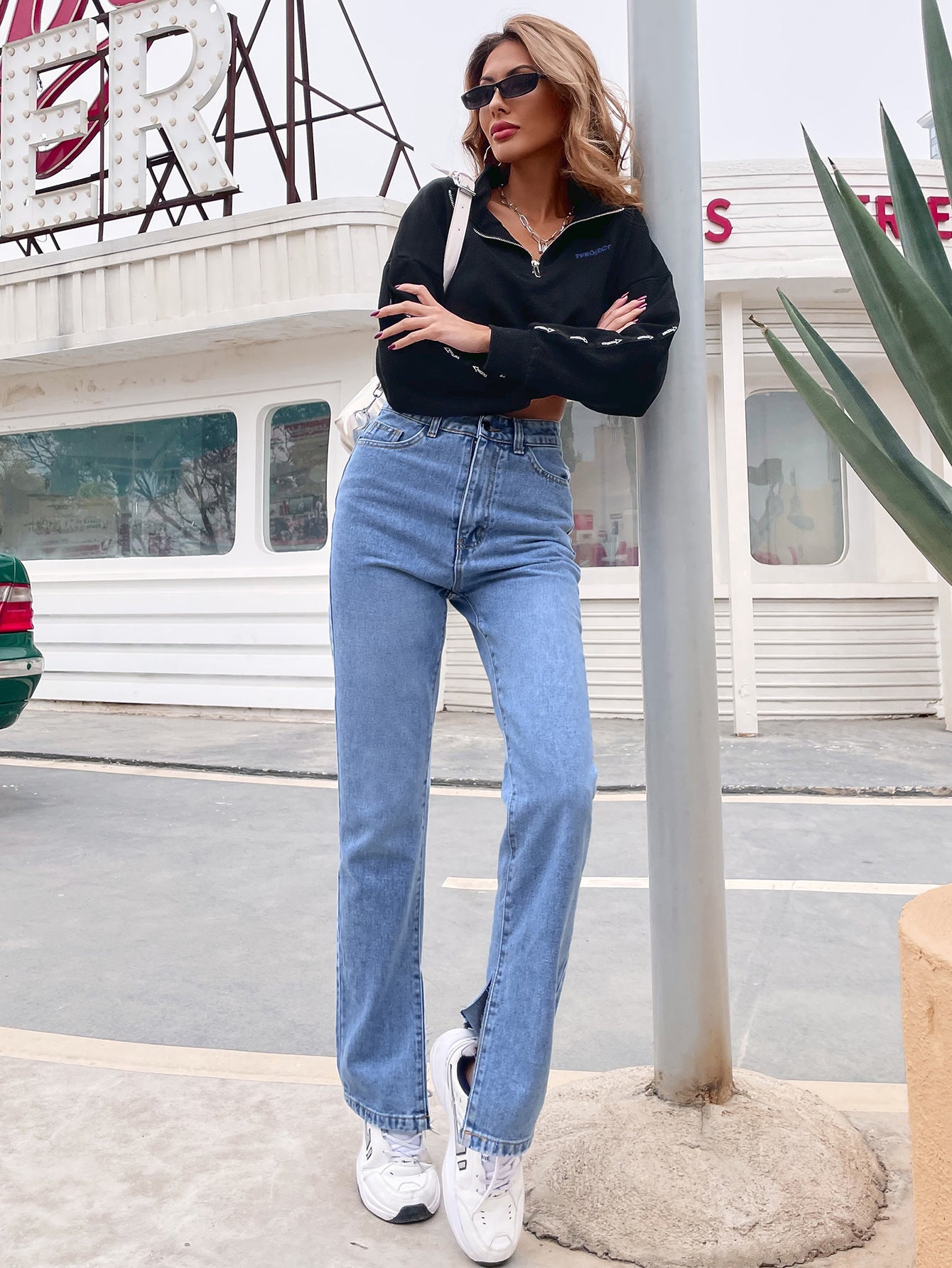 Women’s light wash high-waisted denim pants with front slits for casual fashion style
