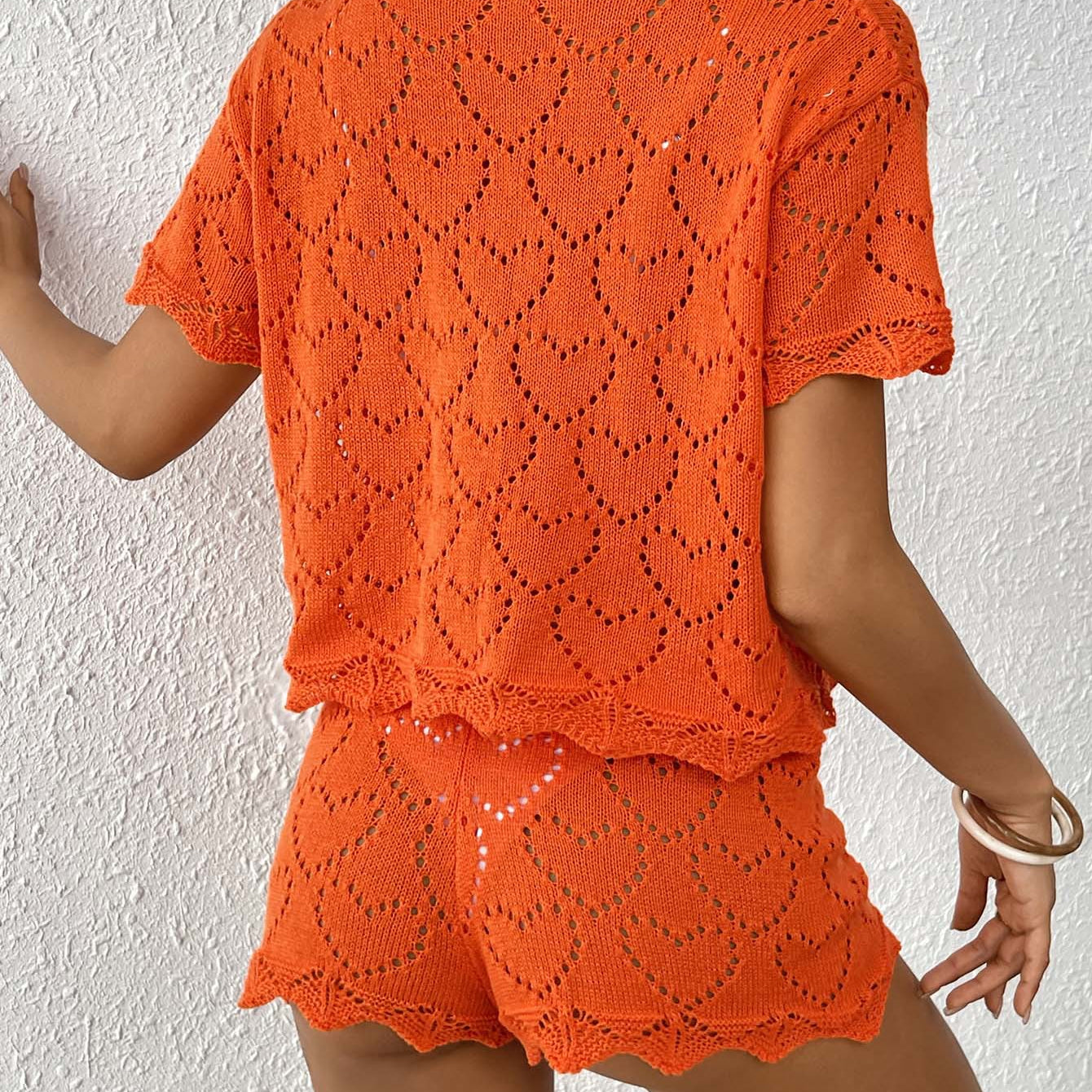 Orange knit two-piece set for women featuring stylish sleeve length, ideal for beach fashion
