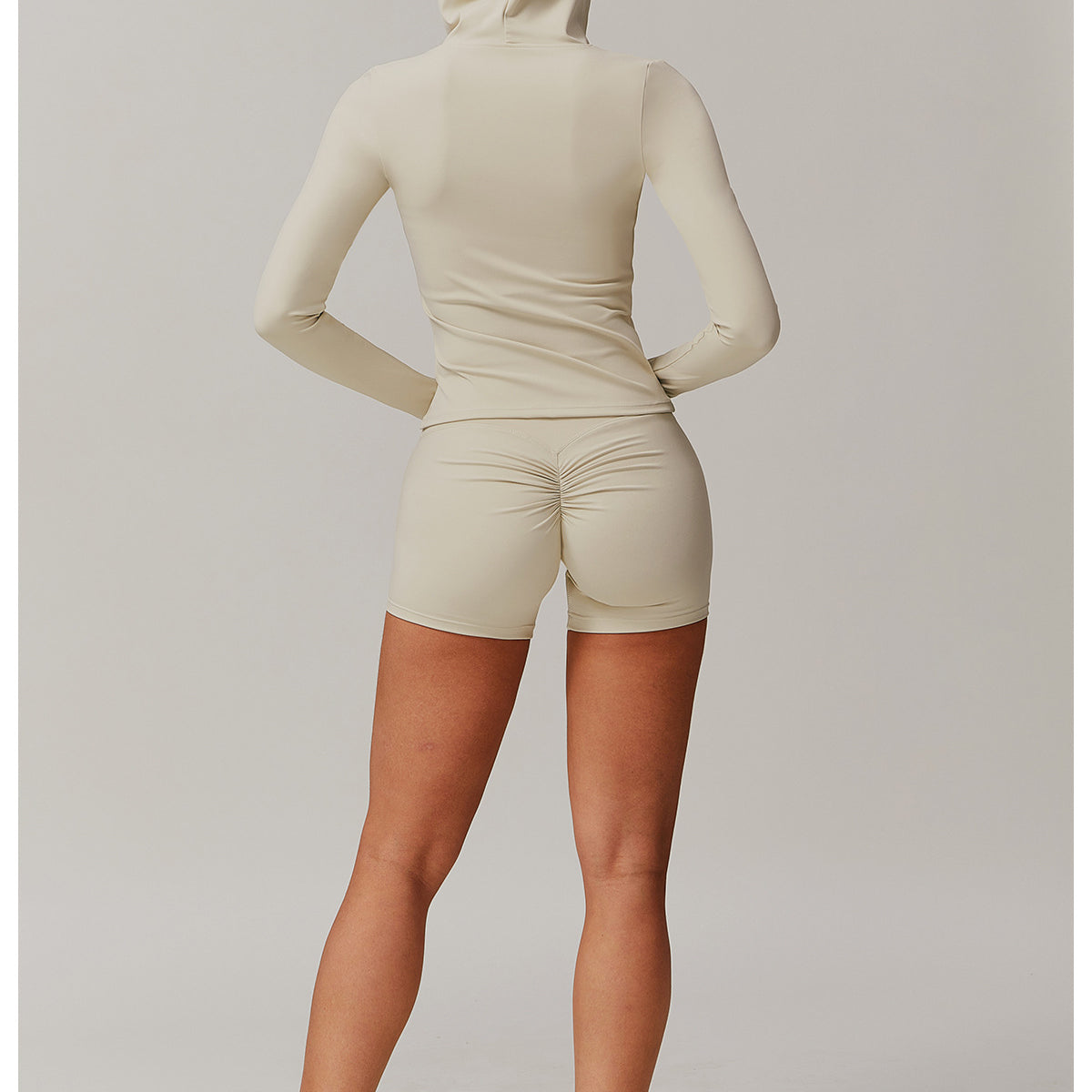 Person in cream-colored outfit and sneakers showcasing the Comfy Slim Fit Soft Jacket in fashion