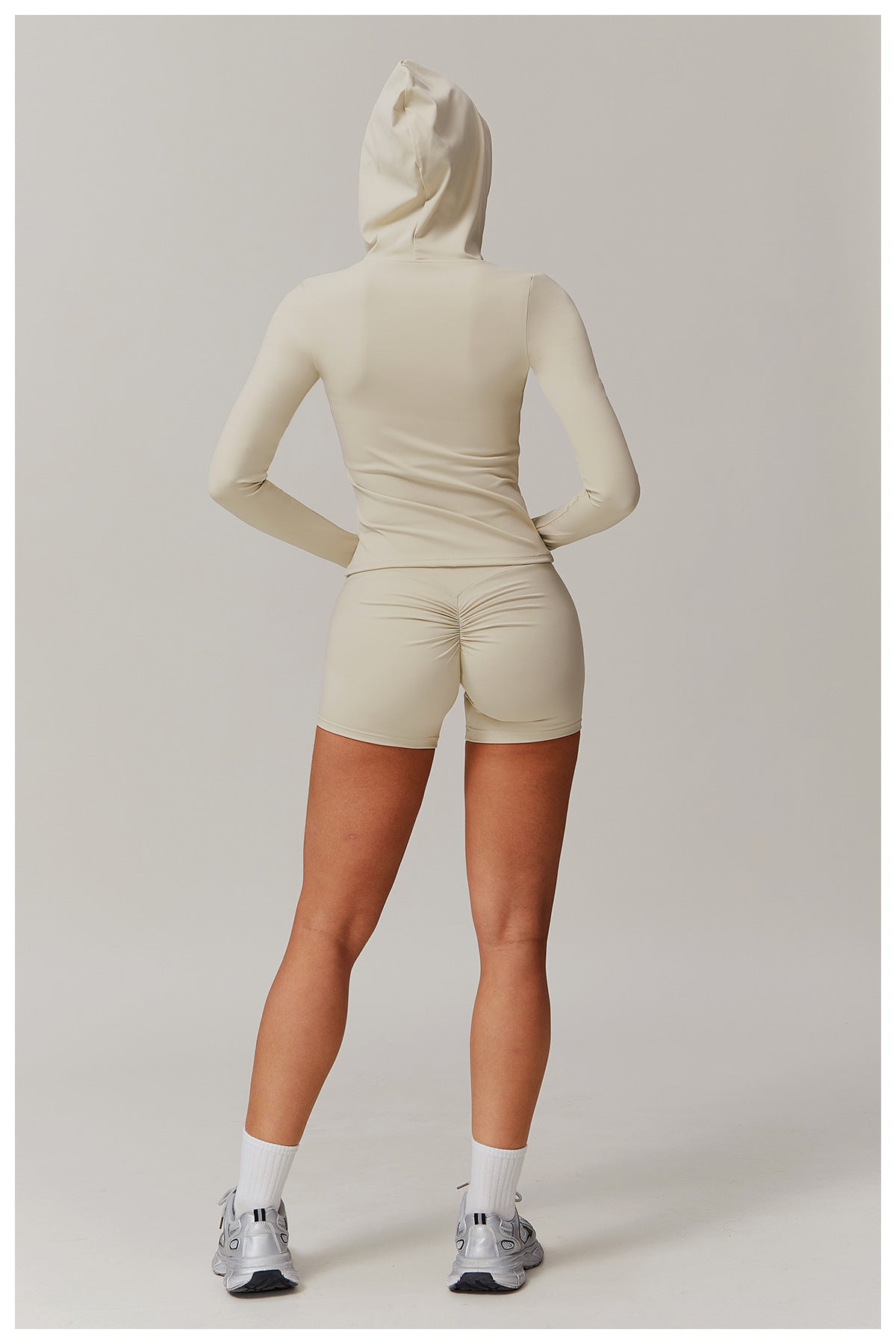 Person in cream-colored outfit and sneakers showcasing the Comfy Slim Fit Soft Jacket in fashion