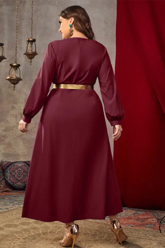 Casual loose high waist A line dress in flowing maroon satin with long sleeves and gold belt