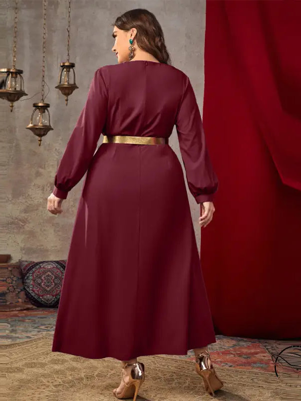 Casual loose high waist A line dress in flowing maroon satin with long sleeves and gold belt