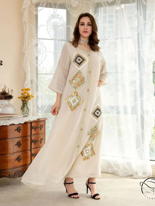 White embroidered maxi dress with floral geometric patterns and lace trim