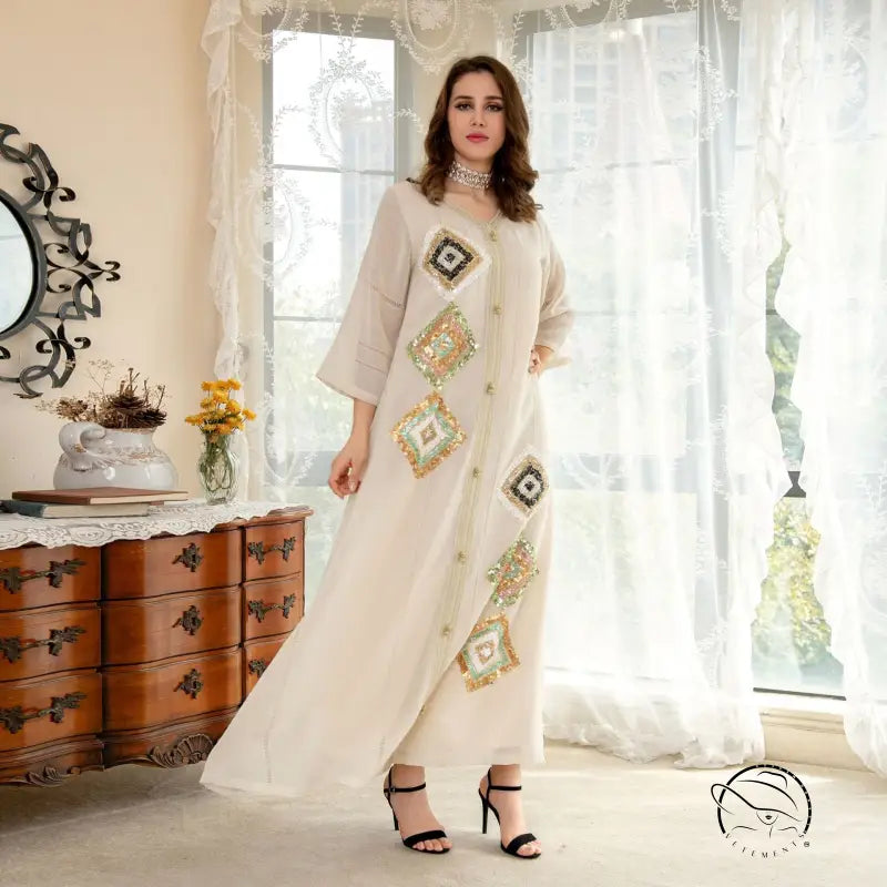 White embroidered maxi dress with floral geometric patterns and lace trim