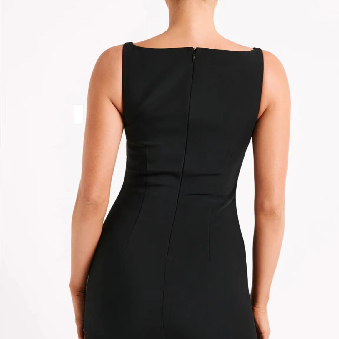 Back view of a sleeveless black mini dress showcasing elegant fashion styling