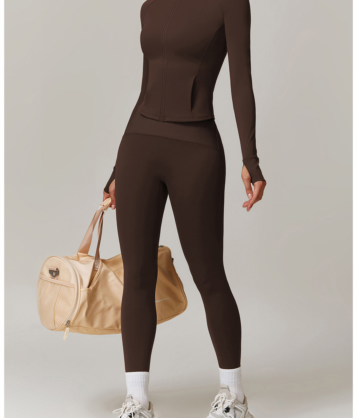 Brown long-sleeved turtleneck jumpsuit with leggings, styled with white socks and chunky sneakers in fashion ملابس