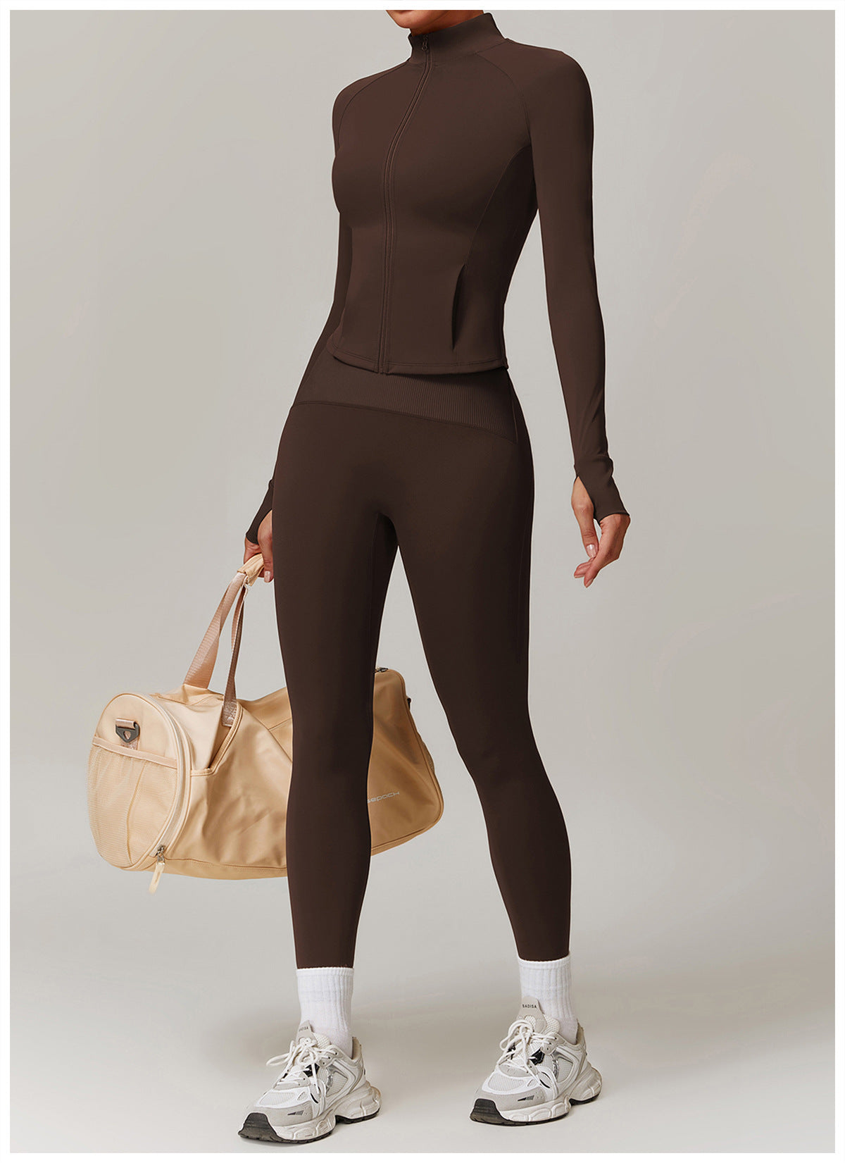 Brown long-sleeved turtleneck jumpsuit with leggings, styled with white socks and chunky sneakers in fashion ملابس