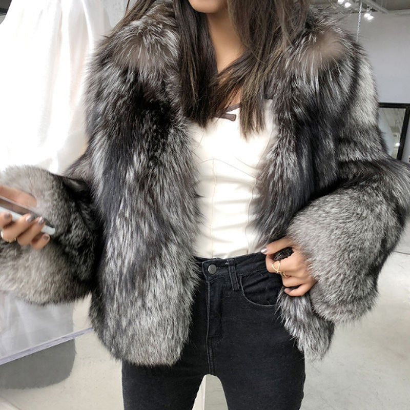 Luxurious silver-gray faux fur coat styled with black jeans and white top for fashion
